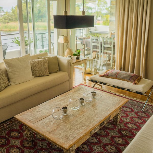 The interior of a modern apartment decorated comfortably with huge windows